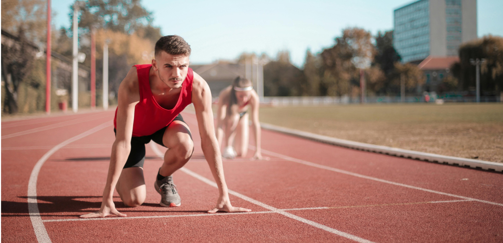 Man on a track preparing to sprint.